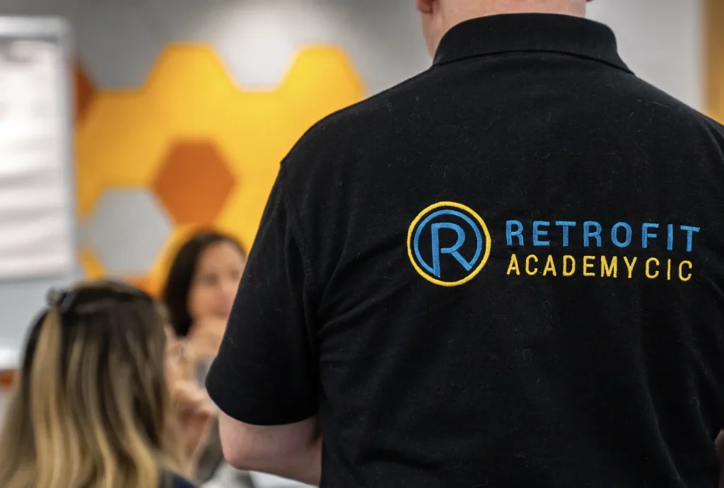 A black Retrofit Academy branded Polo.